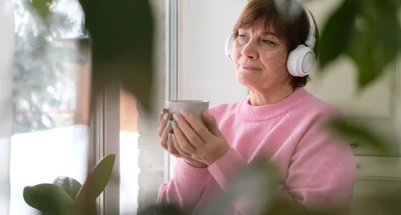 senior-woman-in-pink-savoring-coffee-and-music-by-2023-06-09-22-20-43-utc
